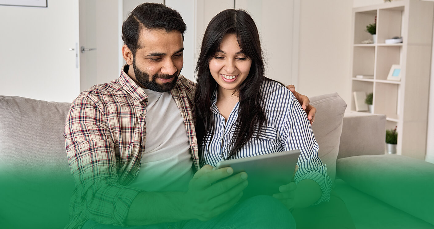 a couple looking at tablet