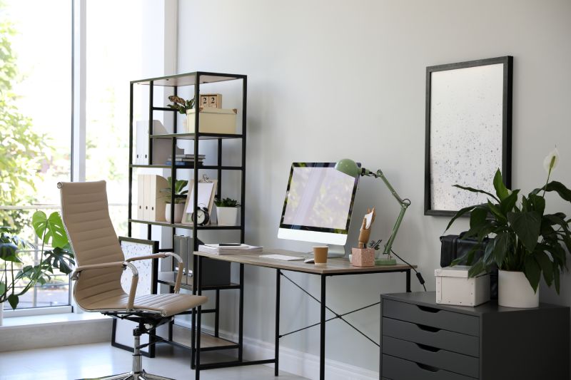 Comfortable office chair near desk with modern computer indoors