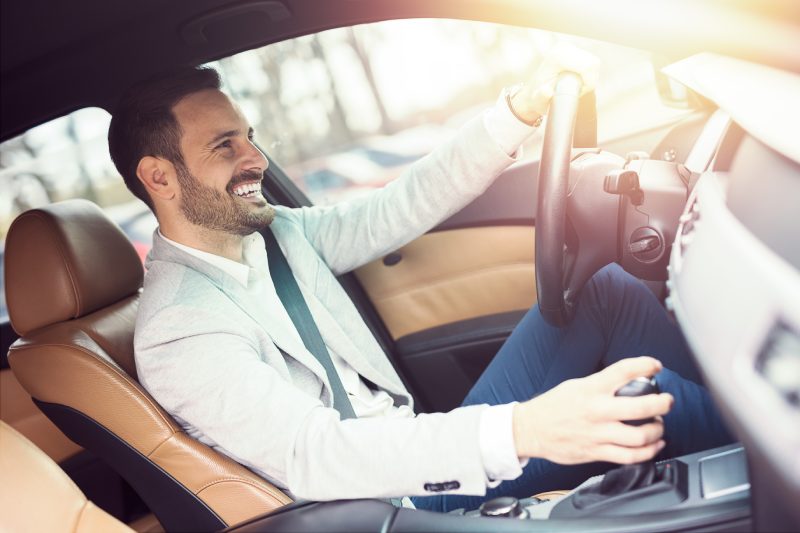 Businessman driving a car.