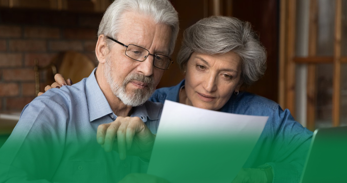 Every paper needs attention. Interested old age married couple do paperwork engaged in reading document. Focused retired spouses study terms conditions of insurance policy think on signing agreement