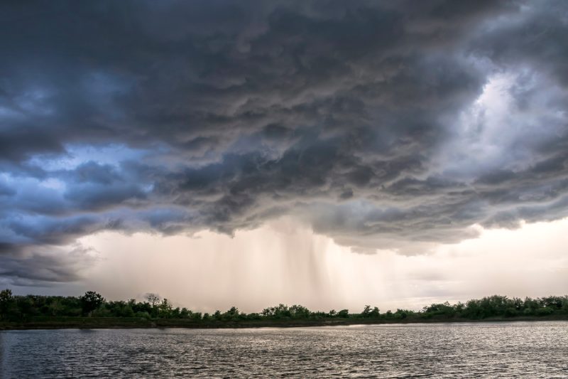 Light in the Dark and Dramatic Storm Clouds background, Black cumulus clouds before the beginning of a strong storm