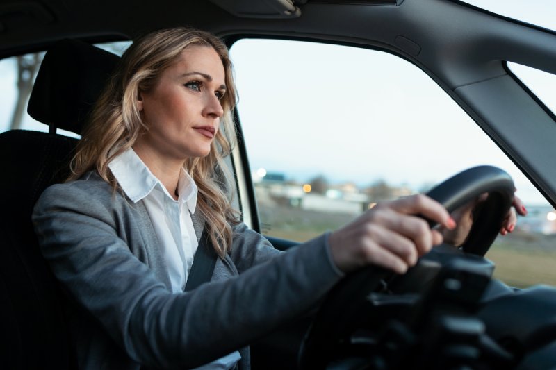 Shot of beautiful mature woman driving her car in the city.