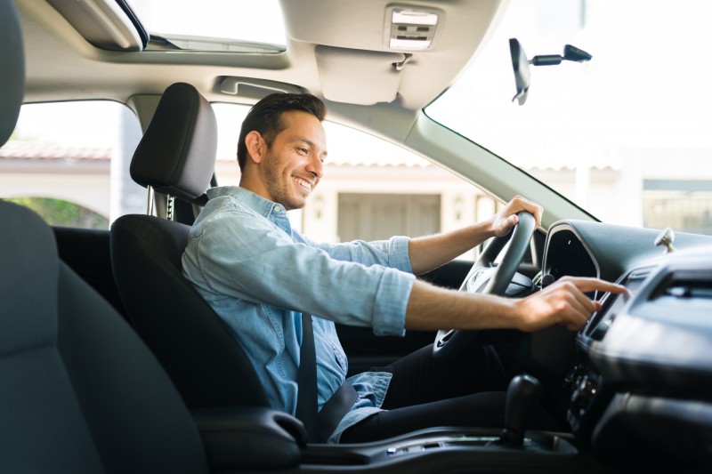 Guy sitting in the driver's seat and smiling.