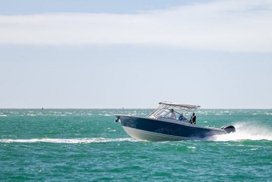 Saltwater fishing boat on a sunny summer day. People on recreational power boat cruising the Gulf of Mexico, Florida.