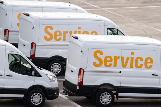 Multiple white vans marked with the word 