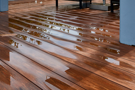 Water leaking and flooded on wood floor. Room floor will damage after the water flooded.