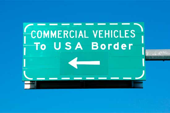 Isolated shot of a sign that directs commercial vehicles to the USA border/Commercial Vehicle USA Border Sign/Isolated shot of a sign that directs commercial vehicles to the USA border