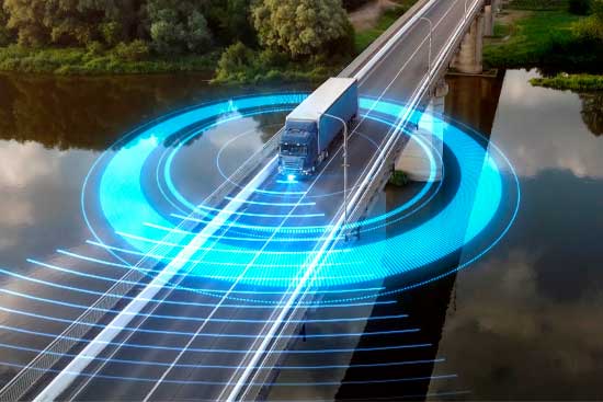 Autonomous semi-truck with a trailer, controlled by artificial intelligence, drives over a bridge over the river. Cargo delivery, transportation of the future. Artificial intelligence. Self driving.